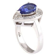 Stamped: 14K White Gold Total Ring Weight: 6.3 Grams Ring Length: N/ARing Width: N/A Gemstone Weight: Total Natural Tanzanite Weight is 2.73 Carat (Measures: 10.50x7.80 mm) Color: Blue Diamond Weight: Total Natural Diamond Weight is 0.40 Carat Quantity: 25 Color: F-G, Clarity: VS2-SI1 Face Measures: 17.30x13.30 mm Sku: [703329W] Tanzanite Brilliant Cut Formal Rings, Classic Pear-shaped Gemstone Rings, Tanzanite Halo Ring For Formal Occasions, Formal Tanzanite Halo Ring Fine Jewelry, Formal Tanzanite Rings With Prong Setting, Classic Tanzanite Ring For Formal Occasions, Formal White Gold Tanzanite Rings, Classic Pear-shaped Gemstones For Anniversary, Formal Tanzanite Sapphire Ring