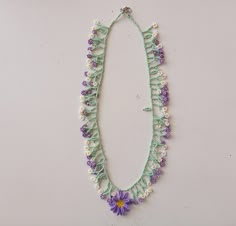 a necklace with beads and flowers on it