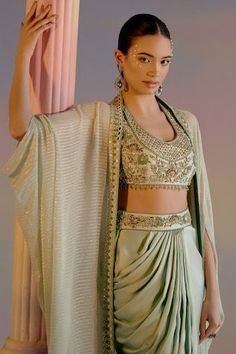 Mint green cape with zari, cutdana, bead and mirror embroidered border. Paired with embellished padded blouse and waistband embroidered draped dhoti skirt. - Aza Fashions Festive Draped Sets With Zari Work, Festive Draped Designer Sets, Draped Cutdana Sets For Designer Wear, Traditional Draped Choli For Party, Traditional Pre-draped Saree For Eid, Festive Traditional Drape Sets, Traditional Designer Lehenga With Side Open, Traditional Draped Lehenga With Sheer Dupatta, Navratri Draped Sets With Zari Work