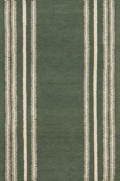 a green rug with white stripes on it