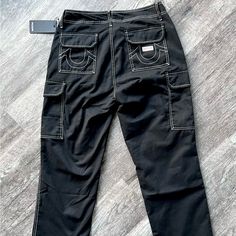 True Religion Jeans Men Size 36 Cargo Pants Jet Black Nwt - Style #108335 Brand New: Ready To Ship Black Straight Leg Cargo Pants With Contrast Stitching, Black Straight Leg Bottoms With Contrast Stitching, Black Bottoms With Contrast Stitching, Black Utility Bottoms With Contrast Stitching, Black Mid-rise Bottoms With Contrast Stitching, Tapered Leg Bottoms With Contrast Stitching For Streetwear, Utility Trousers With Contrast Stitching, True Religion Jeans Men, True Religion Pants