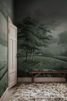 an empty room with a bench in front of a painting on the wall and carpeted floor