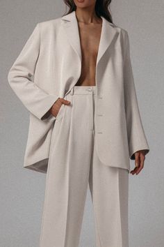 She’s an icon, she’s a legend and she IS the moment. The Icon Tailored Set takes a modern twist on a classic silhouette by featuring an oversized/relaxed fit to give it that edgy, street style flare. Add this to your cart if you’re ready to officially enter your Hailey Bieber era. COLOR: CREAM DETAILS Sold as a set TOP: Single-breasted blazer, relaxed/oversized fit, front button closure, lightly padded shoulders and back belt tightening BOTTOM: Relaxed fit, front zipper and button fastening, twi Elegant Neutral Outerwear With Relaxed Fit, Chic Everyday Blazer, Elegant Everyday White Outerwear, Chic Oversized Outerwear, Everyday Oversized Blazer, Chic Oversized Structured Blazer, Relaxed Fit Blazer For Office, Relaxed Fit Blazer For Workwear, Classic Relaxed Fit Outerwear