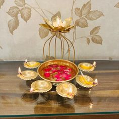 a table topped with gold dishes and candles