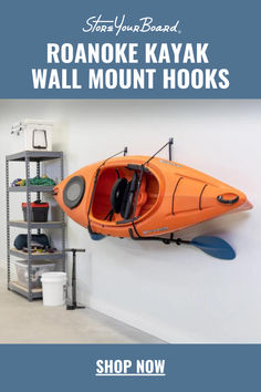 an orange kayak hanging on the wall next to a shelf with earphones and headphones