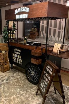 an old fashioned food cart is on display in a building with signs and boxes around it