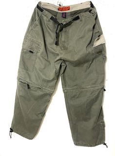 "Rare Vintage Plugg Cargo Utility pants Men's size 32/XL  Olive green  True Vintage 90s  Able to convert into shorts  Skater parachute pants Adjustable: Can fit any size from 32\"-38\" waist" Khaki Cargo Pants With Pockets For Camping, Khaki Parachute Pants For Outdoor Activities, Green Cargo Pants For Hiking, Green Combat Pants For Outdoor Activities, Green Outdoor Cargo Pants, Green Military Cargo Pants For Outdoor, Green Military Style Bottoms For Hiking, Khaki Camping Bottoms With Pockets, Green Cargo Bottoms For Hiking