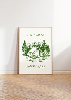 a camp more worry less poster hanging on the wall next to a wooden floor in an empty room