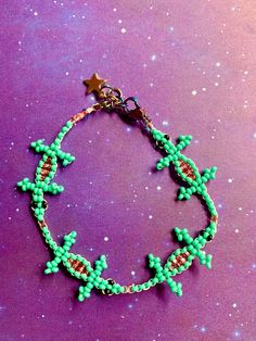 a bracelet with green beads and stars on it