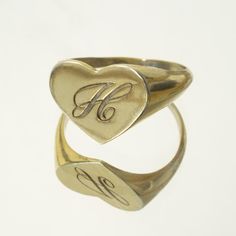 The heart signet ring is a classic, and this one is personalized with an inset monogram. This item is engravable with text or monogram of your choice at no extra cost. The initals are engraved onto the ring and embedded in the 3D model for a flawless embossed finish. You may choose to customize this ring with different images, letters or words. A render of your custom design will be sent to you before production. Heart width: 14mm Heart height: 11mm A few notes about our gold: - Though we do not Vintage 14k Stamped Initial Ring As Gift, Vintage Oval Engraved Ring With Initials, Vintage Personalized 14k Gold Engraved Ring, Vintage Yellow Gold Engraved Initial Ring, Antique Signet Ring With Initials For Formal Events, Vintage Initials Signet Ring, Antique Signet Ring With Initials For Anniversary, Antique Initial Ring In 14k Gold, Antique Style Signet Ring With Engraving Option For Anniversary