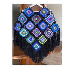 Crochet Poncho with Sleeves, Black Handmade Crochet Granny Square Poncho, Bohemian Fringed Poncho Sweater, Knit Boho Poncho, Multicolor Poncho, Handknitted Patchwork Wool Colorful Festival Poncho, Crochet Poncho, Female Bohemian Grandma Square Poncho, Crocheted Bohemian Poncho 📌📌Features📌 ✅ Applicable: Spring, Summer, Fall ✅ Material: Wool & Acrylic ✅ 100% handmade crochet ✅ Sizes: S/M, L/XL, 2XL/3XL, 4XL/5XL. If you would like another design/specific size, please contact me.  ✅ All my items Crochet Granny Square Poncho, Boho Grandma, Crochet Poncho With Sleeves, Granny Square Poncho, Poncho Au Crochet, Poncho With Sleeves, Festival Poncho, Colorful Festival, Poncho Pullover