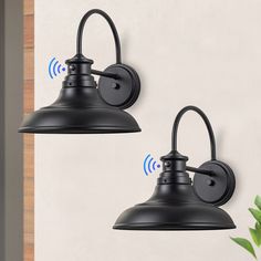 two black outdoor wall lights with wifi signals on the back and side of them