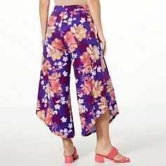 Antthony Mesh Wrap Pull-On Cropped Pant These printed wrap-front pants with a chiffon overlay are a stylish way to work a statement look into your fashionable lifestyle by offering effortless elegance. Beach Floral Print Wide-leg Pants, Printed Ankle-length Pants For Vacation, Spring Vacation Capri Bottoms, Floral Print High-waisted Beach Pants, Chic Purple Bottoms With Floral Print, Wide Leg Floral Print Bottoms For Beach Season, Floral Print Ankle-length Vacation Bottoms, Purple Beach Pants For Spring, Purple Pants For Spring Beach Outing