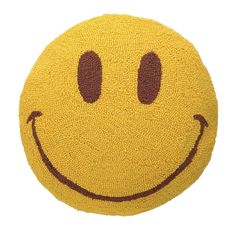 a yellow smiley face rug with two eyes and one smile on the front, is shown