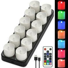 twelve tealight candles with remote control and multicolored leds on black background