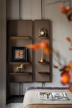 a room with a bed and some shelves on the wall