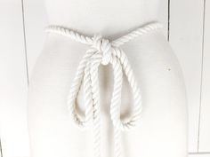 a close up of a white belt on a mannequin's torso,