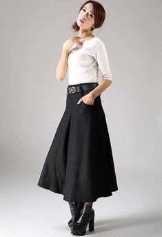 "Update your smart casual wardrobe with this black wool skirt. Classic in style with a modern twist, this pleated skirt will soon become your favorite. Handmade in beautiful soft wool and fully lined, this long skirt will be your staple this winter. Team the women's skirt with a crisp white blouse, some ankle boots and other accessories for an instantly classic look for any occasion. The woman skirt features a pleated front and back and has two pockets. DETAILS: * wool blend * polyester lining * Elegant Flared Skirt With Pockets, Black Box Pleat Pleated Skirt For Work, Elegant Pleated Skirt With Pockets For Work, Chic Black Skirt With Box Pleat, Elegant Black Skirt With Box Pleat, Black A-line Skirt With Pleated Waist, Elegant Black Box Pleat Skirt, Black Pleated Maxi Skirt For Office, Black A-line Skirt With Pleated Hem