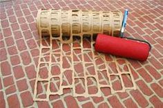 a roll of toilet paper sitting on top of a red brick floor next to a roller