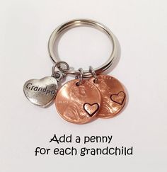 two coins are attached to a keychain that says dad or mom ketchain