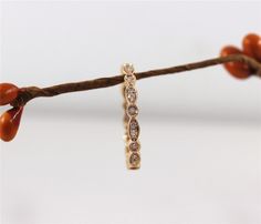 a close up of a ring on a string with some beads hanging from it's end