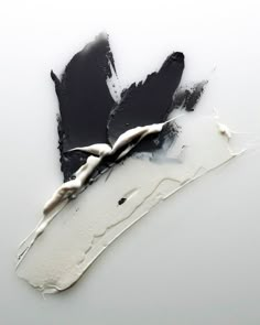 black and white paint is being used to create an abstract painting