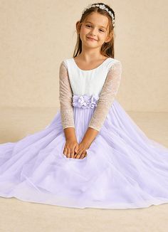 The Mae flower girl dress is a stunning A-line design that combines matte satin and delicate tulle with lace accents. Featuring an elegant illusion scoop neckline, long sleeves, and a stylish V-back with a zipper, it’s beautifully finished with charming bows, making it perfect for a fairytale wedding. Mauve Flower Girl Dress, Long Sleeve Flower Girl Dress, Flower Girl Dress Long Sleeve, Lilac Flower Girl Dresses, Military Ball Dresses, Sage Dress, Special Event Dresses, Ivory Flower Girl Dresses, Lace Bride