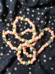 two bracelets made out of candy on top of a bed covered in star patterned fabric