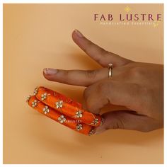 PRODUCT DETAILS: Product Code: AESB-2208-32 Color: Solid colours (Set of 2) Color Variants:  Fire Orange, Hot Pink, Indigo,Parakeet,Turquoise Material: Plastic, Bead and Silk Sizes: 2.6 & 2.8 (It is advisable to take 1-size larger than your regular bangle size) Dimension: 20 grams in weight (for 2 pieces) Description: Each set of bangles contains a set of 2 bangles of a single color. They are beautiful silk-thread bangles with a gold thread twined over it interspersed with gold bead embelishment. bangle is a single solid color. They add such an amazing touch to your outfit! It is great for stacking or layering, too. The bangle is made of plastic, hence is flexible and stress-resistant. Please message us for any further details.  Shipping: The shipping period varies from place to place. Shi Orange Silk Thread Bangles, Orange Bracelet For Festivals As Gift, Orange Bracelets As Festival Gifts, Orange Festival Bracelet As Gift, Orange Bracelets For Festivals Gift, Orange Bangle For Festivals, Orange Festival Bangle Jewelry, Adjustable Orange Bangle For Gift, Adjustable Orange Bangle As Gift