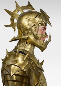 a golden helmet with spikes on it and a face that looks like a man's head