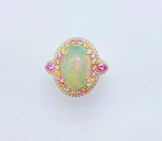 LAST CALL, LAST CHANCE LIQUIDATION SALE The Following Item we are offering is a Rare Important Radiant 18KT Gold Large Fancy Fiery White Opal Diamond Pink Sapphire Ring. Ring is comprised of A LARGE Gorgeous Fancy Fiery White Rainbow Opal surrounded by a Beautiful Halo of Fancy Rainbow Sapphires, surrounded with a Halo of Diamonds, and Pink Sapphire Baguettes on each side. T.C.W APPROX 8 CTS Comes with New with Tags from a Private Manufacturer that sells to Important 5 Star Hotel and Fine Jewelr Rainbow Opal Ring, Rainbow Diamond, Rainbow Sapphires, Rainbow Opal, Liquidation Sale, Pink Sapphire Ring, White Rainbow, Sapphire Diamond Ring, Star Hotel