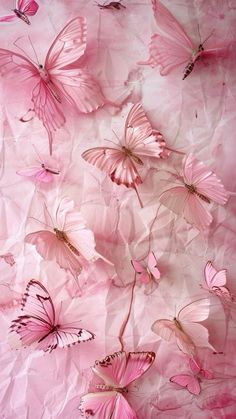 pink butterflies are flying in the air on crumpled paper with watermarked images behind them