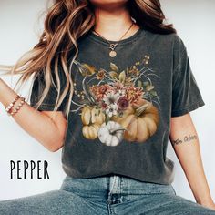 👀Images are an accurate depiction of what you'll receive upon purchase ♂️ All Shirts are Unisex Sizing 👣 Printing is "Direct To Garment"  (Ink printed). Introducing our stunning new Autumn Vibes t-shirt, a delightful fusion of cozy comfort and captivating autumn charm. Our autumn-inspired design captures the essence of the season, with intricately detailed pumpkins that evoke feelings of warmth and abundance. The enchanting autumn foliage adds a touch of natural elegance, depicting the vibrant Fall Graphic Tee With Vintage Print, Fall Cotton T-shirt With Vintage Print, Short Sleeve Floral Print Tops For Fall, Fall Custom Print Short Sleeve Tops, Fall Printed Cotton T-shirt, Fall Cotton Printed T-shirt, Cotton Graphic Tee With Digital Print, Custom Print Short Sleeve Tops For Fall, Printed Cotton T-shirt For Fall