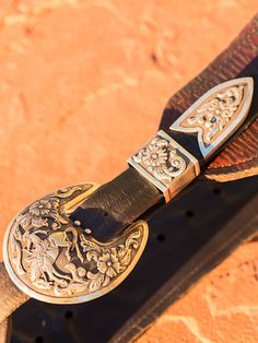 Nothing better than hand scrolled and engraved ranger buckles with bucking horses. I sure love our Wyoming heritage "Let's go Cowboy!" Each element is sawn out of thick sterling, and stamped and engraved. True works of art! "Ranger" buckles are inspired, artful creations. They look amazing with our vintage latigo belts or Wild West turquoise concho belts. A beautiful combination of hand carved floral designs. We can do brands logos, you name it we can do it! Western Hand Tooled Belt Buckles For Rodeo, Western Style Engraved Belt For Ranch, Western Style Engraved Belts For Rodeo, Engraved Western Belt For Ranch, Vintage Hand Tooled Belt Buckles For Rodeo, Western Engraved Belts For Rodeo, Western Style Silver Belt For Western-themed Events, Western Silver Belt For Western-themed Events, Western Style Engraved Adjustable Belts