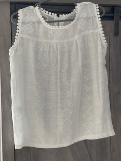 "I'm so in love with these tanks! Absolutely beautiful, perfect for layering with that perfect splash of sweetness! Layer now with a jean jacket and leggings, wear alone with shorts when the weather warms! 🌞Tanks are a flowy, longer length. 2-3 year is 17\" from shoulder to hem. More Razels!" Sleeveless Cotton Tops With Lace Trim, White Camisole With Floral Embroidery For Spring, Summer Tank Top With Floral Embroidery For Vacation, Embroidered Cotton Tank Top For Beach, Summer Floral Embroidery Tank Top For Vacation, Summer Vacation Tank Top With Floral Embroidery, Vacation Camisole Top With Floral Embroidery, Floral Embroidered Camisole Tops For Vacation, Cotton Tank Tops With Crochet Trim