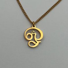 "A piece that embodies the power of the \"Om\" symbol, bringing inner peace and harmony to every moment. This XS Om II is made in Tamil script and Gold plated." Tamil Om Pendant Gold, Tamil Script, The Om Symbol, Om Necklace, Om Pendant, Om Symbol, Gold Ring Designs, Peace And Harmony, Mens Pendant