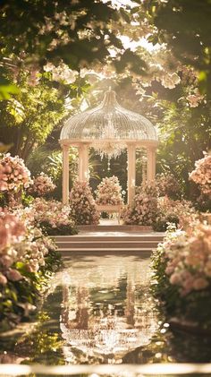 a gazebo surrounded by pink flowers and greenery