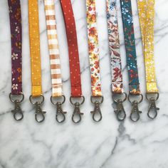 "These lanyards are perfect for any new driver, teacher, nurse, or anybody that needs an extra hand! Choose between fun fall prints! Each lanyard is approximately 1/2\" inch wide and 19 inches from the tip of the metal to the end of the fabric (where it starts to curve!) and sewn with a twist so it lays flat on your chest. If you would like for it to be sewn flat (without the twist) just leave a note to seller at checkout! You have the option for a lobster clasp, or a lobster clasp and split rin Lanyard Teacher, Fabric Lanyard, Teacher Lanyard, New Driver, Fall Prints, Fall Fabric, New Drivers, Dotted Fabric, Plaid Fabric