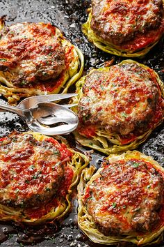 four spaghetti cakes with meatballs and sauce on top