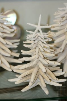 white christmas tree ornaments are displayed on a table