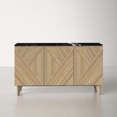 the sideboard is made out of wood and has black marble inlays on top