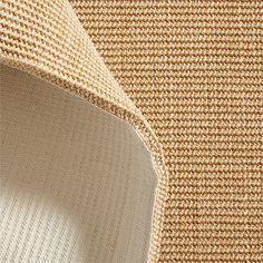 close up view of the textured fabric on an area rug that is beige and brown