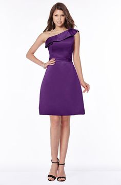 a woman in a purple dress posing for the camera with her hands on her hips