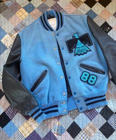 SUPER RARE baby blue wool & leather Thunderbird varsity letterman jacket. Marked size 42, fits like mens large, check measurements below. Overall good condition with a lightly faded spot where a previous patch was. MEASUREMENTS: Chest: 23" across Length: 25" Sleeve: 25" Shoulders: 19" across Blue Vintage Cotton Varsity Jacket, Blue Varsity Jacket With Patchwork, Blue Patchwork Varsity Jacket, Retro Blue Outerwear With Baseball Collar, Collegiate Blue Varsity Jacket For Fall, Blue College Varsity Jacket With Button Closure, Blue Varsity Jacket With Button Closure For College, College Blue Varsity Jacket With Button Closure, Blue Patchwork Varsity Jacket For Streetwear