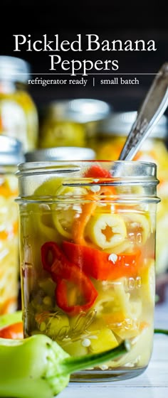 pickled banana peppers in a glass jar with a spoon