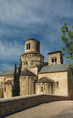 an old stone building with two towers on top