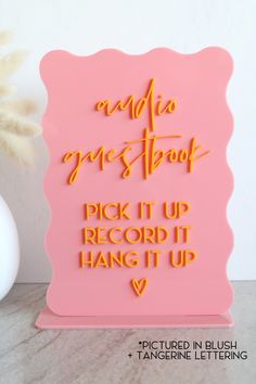 a pink plaque with the words music goes through pick it up, record it hang it up