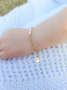 "Pearl and Gold Baby Bracelet/ 14 K Gold Filled Toddler Bracelet/ Little Girl Bracelet with Initial/ Baby Bracelet with Heart Charm Precious little bracelet is perfect for newborn gift, baptism/christening gift, 1st birthday gift, or just to show you care gift!! Stunning as flower girl bracelet too!! Really any occasion! Four delicate, 4 mm fresh water pearls adorn this golf filled bracelet. Gold Filled Chain is 2x2.3 mm, making this a sturdy chain that resists breaking from yanks or tugs of lit Adjustable Gold Bracelet With Pearl Charm As Gift, Adjustable Pearl Charm Bracelet For Birthday, Personalized Round Bracelets, Toddler Bracelet, Girl Bracelet, Flower Girl Bracelets, Bracelet With Heart, Bracelet Pearl, 1st Birthday Gifts