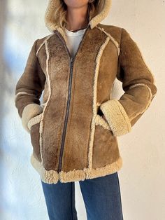 "- Vintage Wilsons shearling lined suede leather jacket  - Plastic zipper up the front - Hooded - Beautiful patina - Tagged 6  Chest: 17\" Length: 27\" Sleeve: 22\" Shoulder: 15\"" Winter Sheepskin Outerwear With Zipper Closure, Winter Shearling Leather Jacket With Zipper Closure, Winter Shearling Leather Jacket With Zipper, Winter Shearling Outerwear With Zipper Closure, Winter Suede Outerwear With Zipper Closure, Winter Brown Leather Jacket With Suede Lining, Brown Leather Jacket With Suede Lining For Winter, Winter Shearling Leather Jacket With Zip Fly, Brown Winter Outerwear With Suede Lining