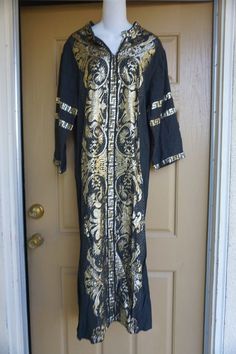 Vintage gold embroidered Dress. Made in Greece. No size labeled - estimated medium - see measurements. In good vintage condition. Measurements taken across front laid flatBust: 21"Waist: 21 "hip: 21"Length (shoulder to hem): 53"Condition: Good Gold Long Sleeve Ceremonial Dress, Gold Long Dress For Festivals, Long Gold Dress For Festivals, Long Gold Dresses For Festivals, Greek Embroidered Dress, Festive Floor-length Kaftan With Gold Embroidery, Festive Black Kaftan With Gold Embroidery, Black Long Kaftan With Intricate Embroidery, Fitted Black Embroidered Kaftan